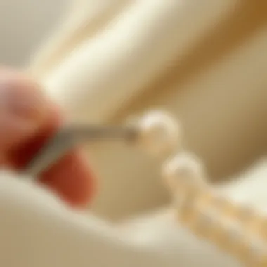 Close-up view of a pearl being knotted