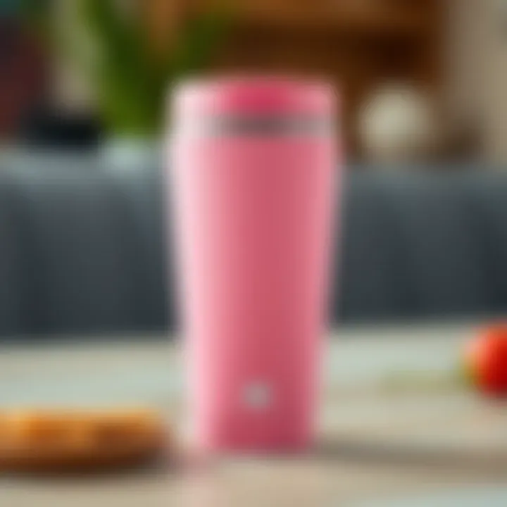 Close-up of pink travel coffee mug with design details