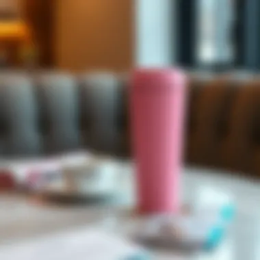 Elegant pink travel coffee mug on a stylish table